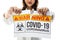 Woman holding and tearing paper with Covid-19 coronavirus warning words. The idea or concept for the ending, happiness, free, and