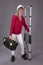 Woman holding a telescopic ladder and toolbox