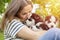 Woman holding three wonderful purebred husky puppies in her hands outdoors. A woman huging husky puppies