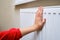 Woman holding on to the radiator, adult hand on the heating system cl