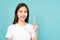 Woman holding toothbrush with braces on teeth isolated on blue background, Concept oral hygiene and health care.