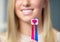 Woman holding toothbrushes forming a heart
