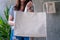 Woman is holding tote bag canvas fabric for mockup blank template.