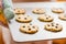 Woman holding a tray with baked cookies with kitch