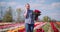 Woman Holding Tulips Bouquet in Hands While Talking on mobile Phone on Tulips Field