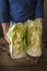 Woman holding two halves of the Chinese cabbage on the table