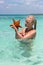 Woman holding two starfishes in her hands