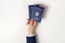 Woman holding Ukrainian internal passports on light background