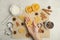 Woman holding unbaked cookie on light table, top view. Christmas biscuits