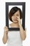 Woman holding up a black picture frame, crying