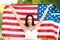 woman holding USA flag outdoor