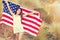 Woman holding USA flag outdoor.