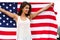 Woman holding USA flag outdoor.