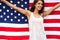 Woman holding USA flag outdoor.