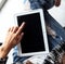 Woman holding and using tablet with empty screen