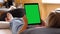 Woman Holding a Vertical Green Screen Tablet, Lying on the Bed