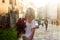 Woman holding a vivid bunch of lilac flowers walking down the street