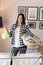 Woman holding a washbowl full of wet clothes