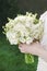 Woman holding white wedding bouquet