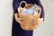 Woman holding wicker basket with dirty clothes. household chores cleaning concept. close-up photo