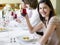 Woman Holding Wineglass With Friends At Dinner Party