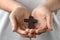 Woman holding wooden Christian cross, closeup view