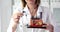 A woman holds an anatomical model of a hair follicle