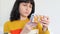 A woman holds a blister with pills in her hand while making a purchase in an online pharmacy using an app on her