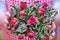 A woman holds a bouquet of dried flowers after the wedding. Red rose female palms when did the romance end, close-up