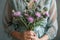 a woman holds a bouquet of thistles