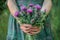 a woman holds a bouquet of thistles