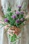 a woman holds a bouquet of thistles