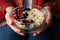 Woman holds bowl with oatmeal porridge with fruits Close up