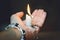 A woman holds a burning candle in her hand. Melted wax drips onto the skin
