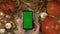 Woman holds cellphone with green screen and makes swipes and taps with right hand