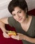 Woman Holds Cheeseburger Between Bites Eating