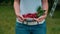 Woman holds a cherries inside T-shirt