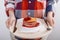 Woman holds cutting board with plate American Pancakes with raspberry jam, food advertising concept. Closeup, selected