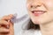 A woman holds dental mouthguard, splint for the treatment of dysfunction of the temporomandibular joints, bruxism