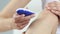 Woman holds a depilator in her hands and starts shaving her legs. Close up