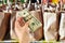 Woman holds dollars in a supermarket. shopping concept. Close-up. Hand with dollars on the background of shopping bags with grocer