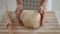 Woman holds dough in her hands and shows at camera. Increasing price of wheat, flour and bread. Homemade bread preparation. Econom