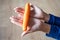 The woman holds food in her hand. the girl holds carrots in her hands. Orange carrot in hand