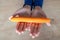 The woman holds food in her hand. the girl holds carrots in her hands. Orange carrot in hand