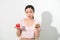 Woman holds in hand cake sweet and apple fruit choosing, trying to resist temptation, make the right dietary choice. Weight loss