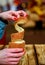 Woman holds in hand Trdlo or Trdelnik, Traditional tasty baked Czech Republic