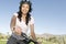 Woman Holds Handlebars Of Mountain Bike