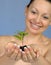 The woman holds in hands soil with a plant