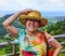 Woman Holds hat in wind