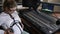 Woman holds headphones on big tummy at radio studio, harmful work